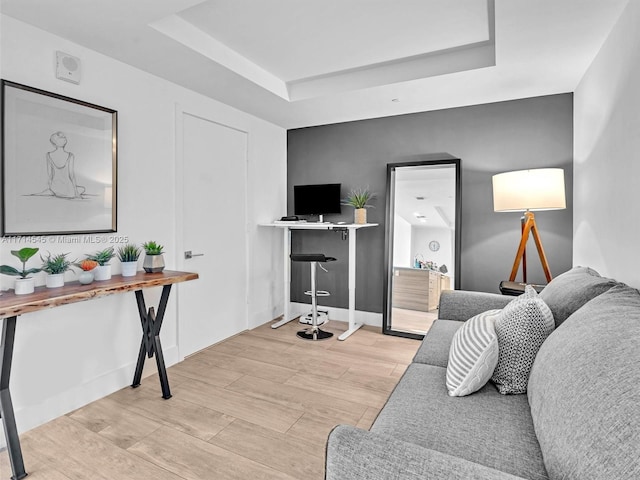 living room featuring a tray ceiling