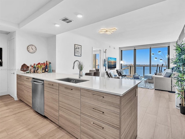 kitchen with sink, kitchen peninsula, expansive windows, and dishwasher