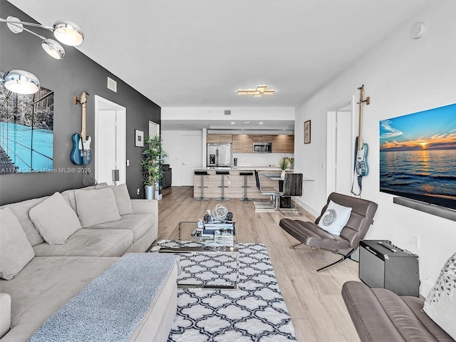 living room with light hardwood / wood-style flooring