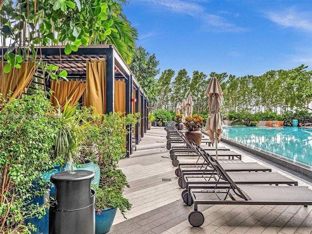 wooden terrace with a community pool