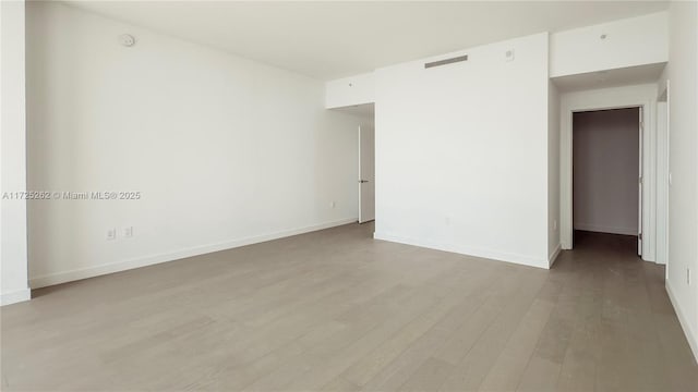 unfurnished room with light hardwood / wood-style floors