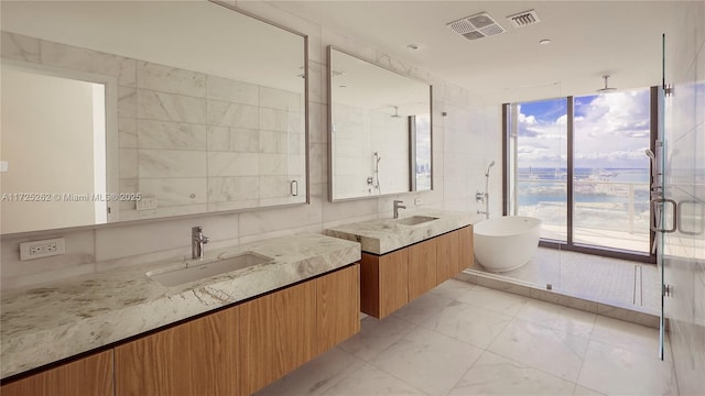 bathroom featuring shower with separate bathtub, vanity, tile walls, and expansive windows