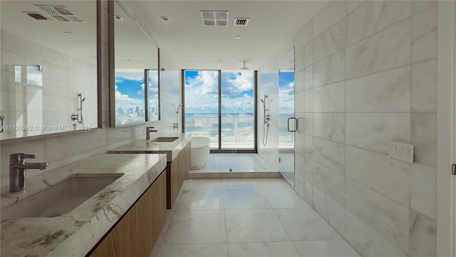 bathroom featuring vanity, tile patterned floors, tile walls, floor to ceiling windows, and independent shower and bath