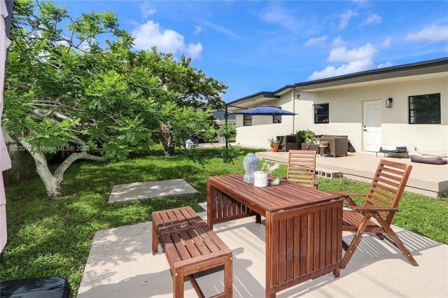 view of yard featuring ac unit, a patio, and central AC