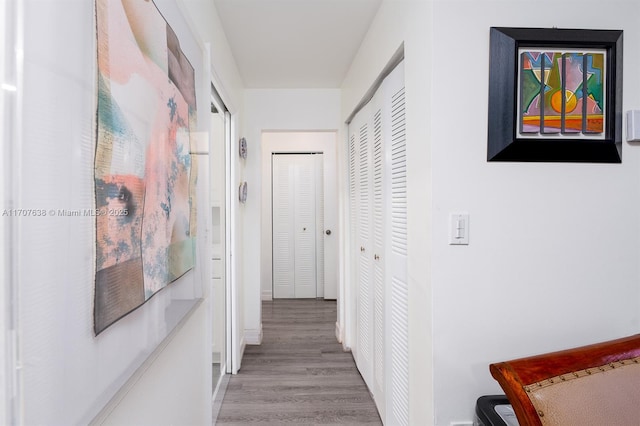 hallway with hardwood / wood-style floors