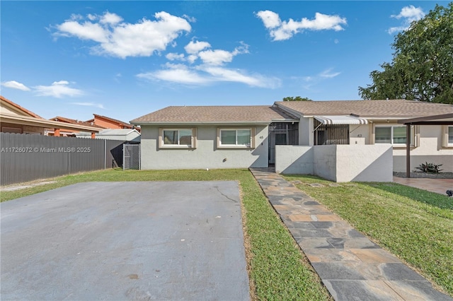 ranch-style home featuring a front yard