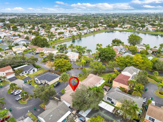 drone / aerial view featuring a residential view and a water view