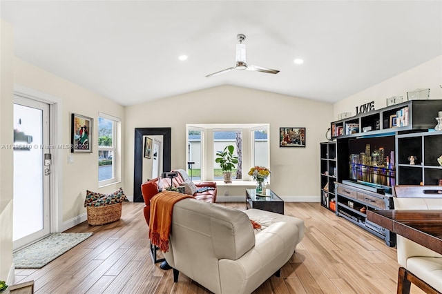 living area with light wood-style floors, ceiling fan, baseboards, and vaulted ceiling