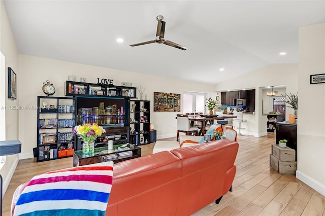 living room with a ceiling fan, lofted ceiling, light wood finished floors, and recessed lighting