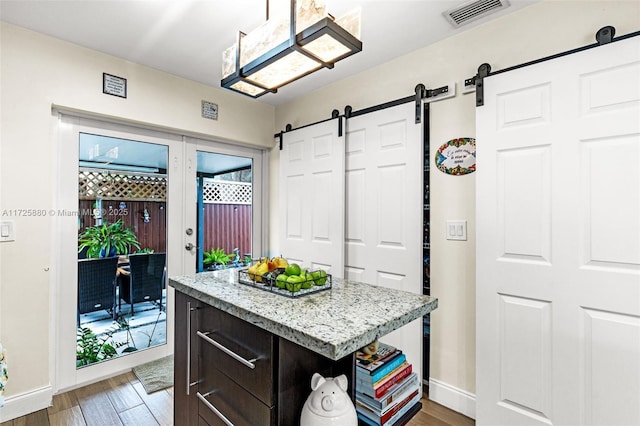 kitchen featuring a center island, hardwood / wood-style floors, and dark brown cabinets