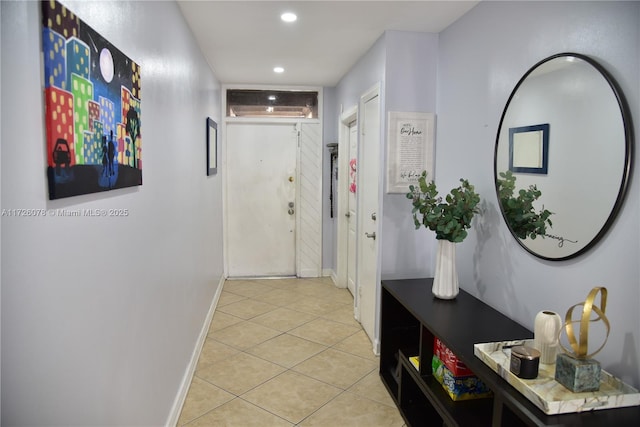 corridor with light tile patterned floors, recessed lighting, and baseboards