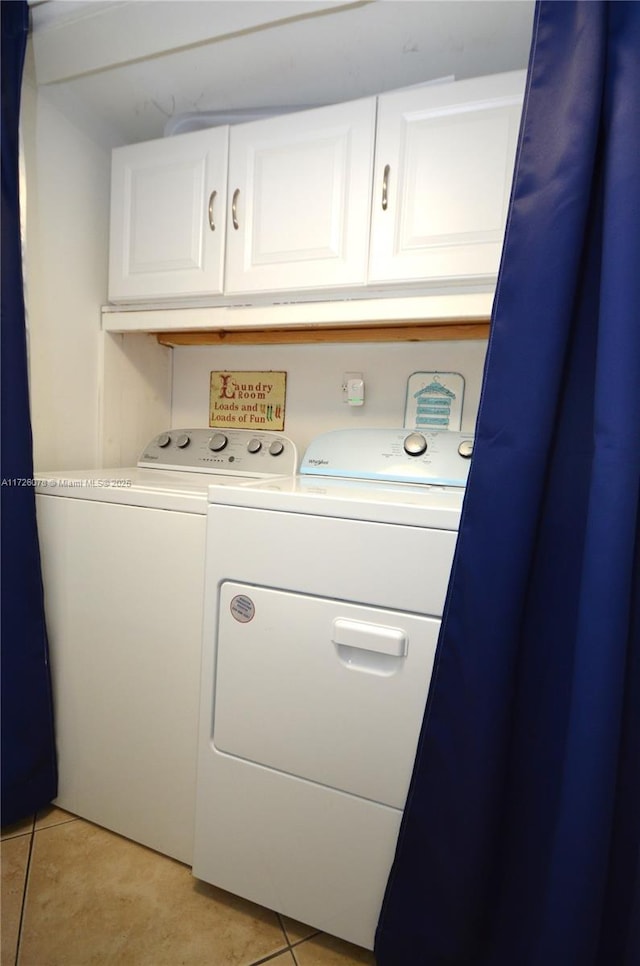 washroom featuring cabinets, light tile patterned flooring, and independent washer and dryer