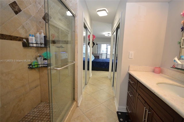 full bathroom featuring tile patterned flooring, vanity, connected bathroom, and a shower stall