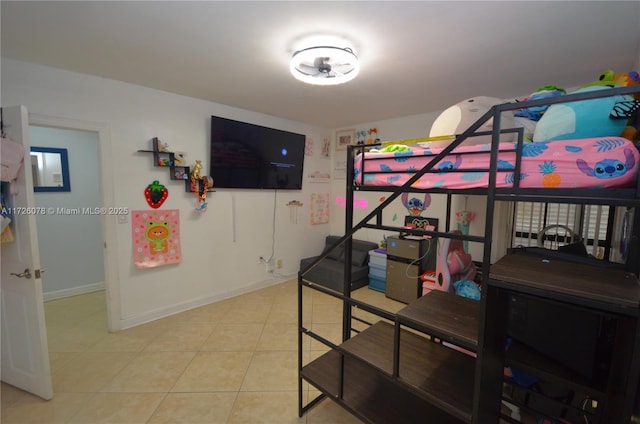 bedroom with light tile patterned flooring and baseboards