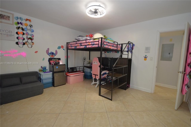 bedroom featuring electric panel, baseboards, and light tile patterned flooring