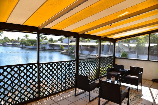 sunroom / solarium featuring a water view