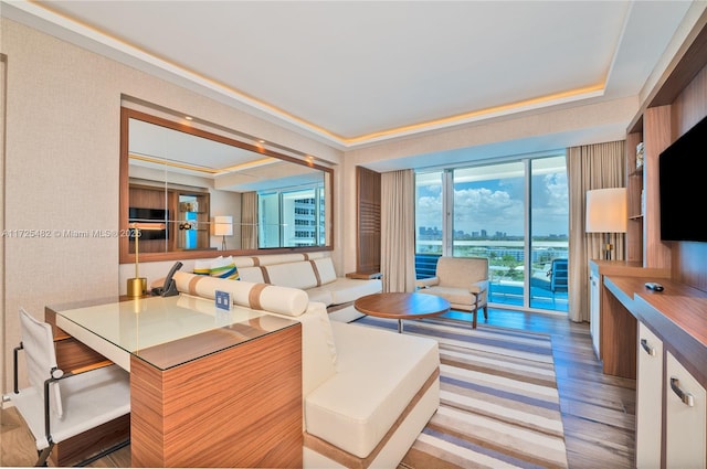 living room featuring ornamental molding and light hardwood / wood-style flooring