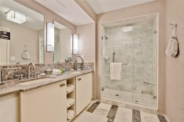 bathroom with vanity, a shower with shower door, and backsplash