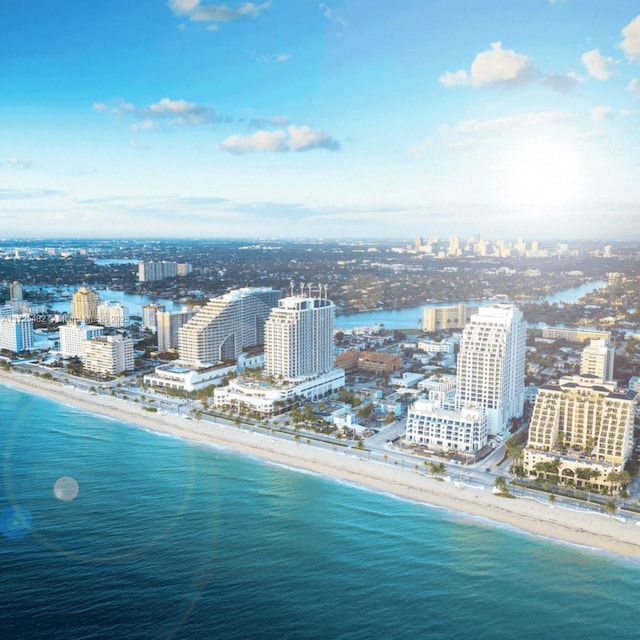 bird's eye view featuring a water view and a view of the beach