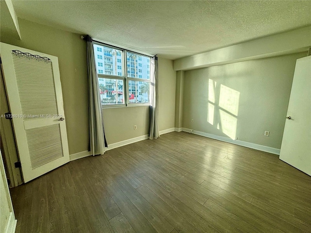 unfurnished bedroom featuring hardwood / wood-style flooring and a textured ceiling