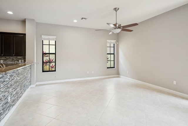 empty room with recessed lighting, visible vents, and baseboards