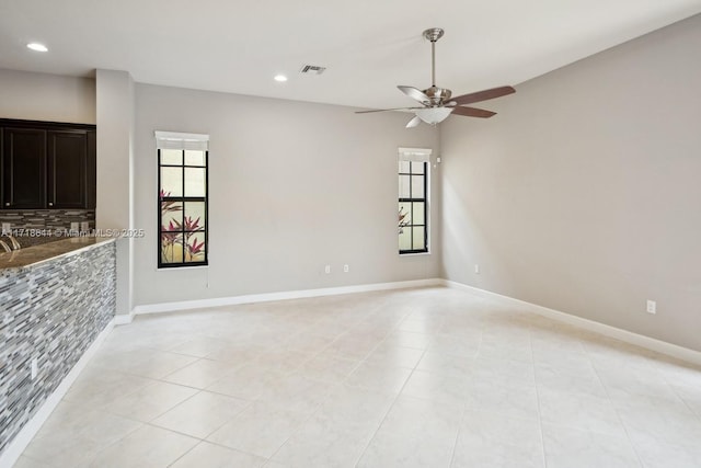 unfurnished room with recessed lighting, a ceiling fan, light tile patterned flooring, and a healthy amount of sunlight