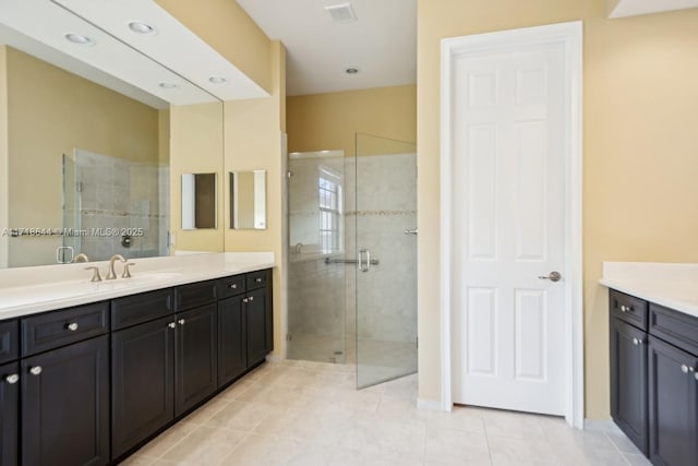 full bathroom with tile patterned floors, visible vents, vanity, and a shower stall