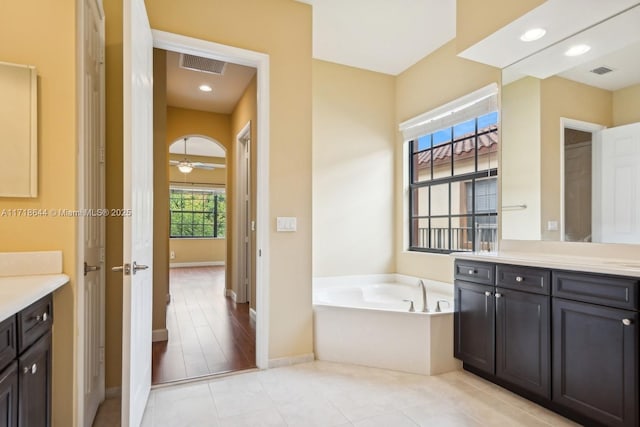 full bath with recessed lighting, visible vents, a garden tub, and vanity