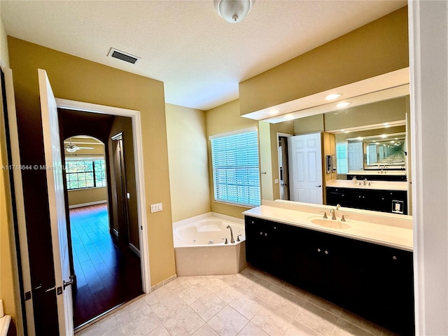 8771 NW 41st St, Cooper City, FL 33024 - bathroom with a tub with jets, vanity, and tile patterned flooring