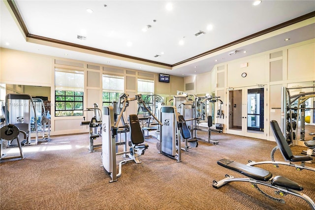 exercise room with visible vents, a tray ceiling, recessed lighting, carpet, and crown molding