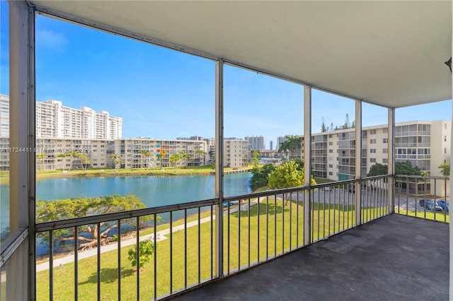 unfurnished sunroom featuring a water view