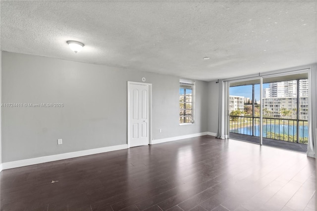 spare room with dark hardwood / wood-style flooring