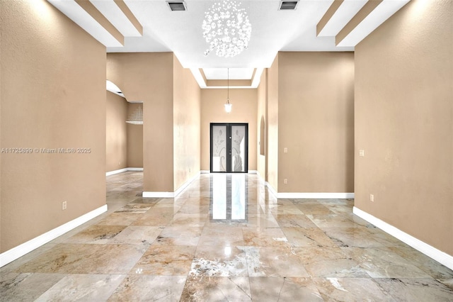 foyer with a chandelier and french doors