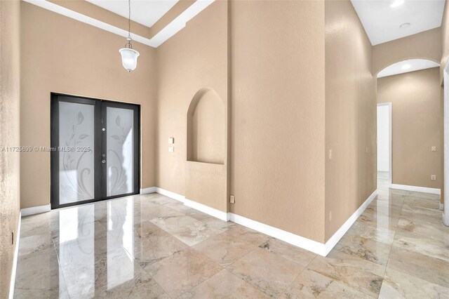 unfurnished bedroom featuring a towering ceiling, two closets, and ceiling fan