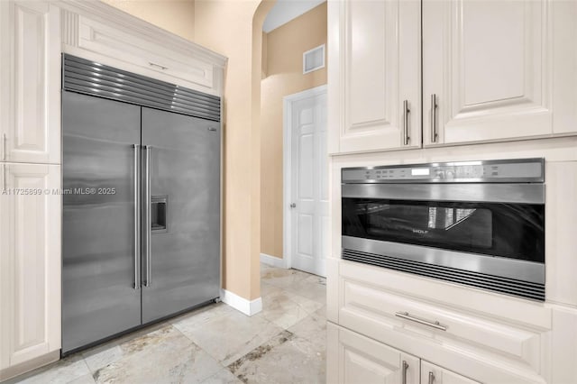 kitchen with appliances with stainless steel finishes and white cabinets