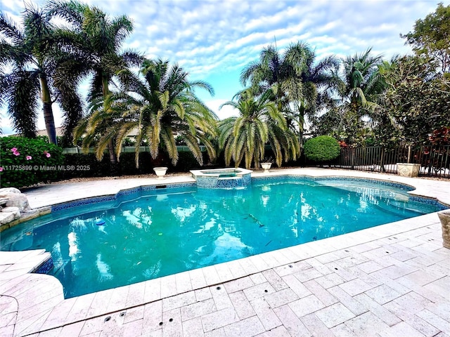 view of swimming pool with an in ground hot tub