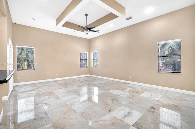 spare room featuring ceiling fan and beam ceiling