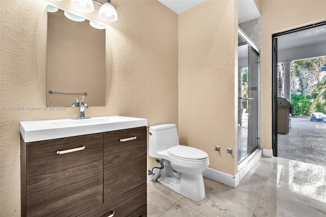 bathroom featuring vanity, toilet, and walk in shower