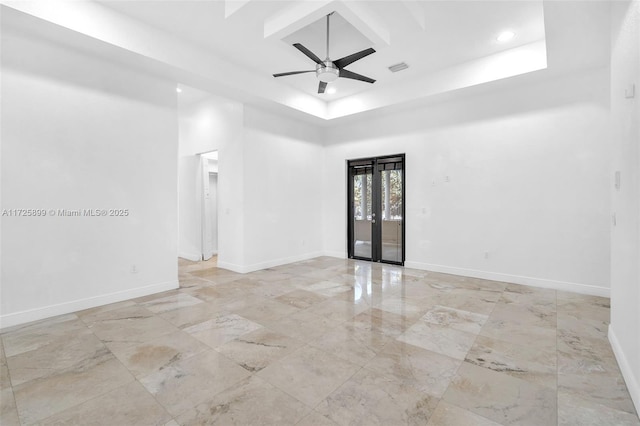 empty room with french doors, ceiling fan, and a high ceiling