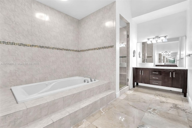 bathroom with vanity, plus walk in shower, and tile walls