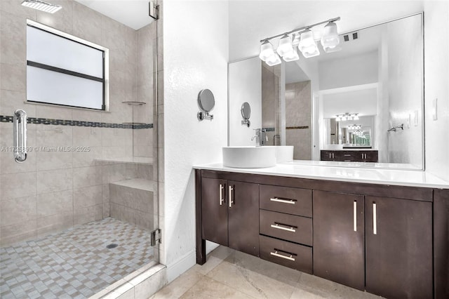 bathroom featuring vanity and a shower with shower door