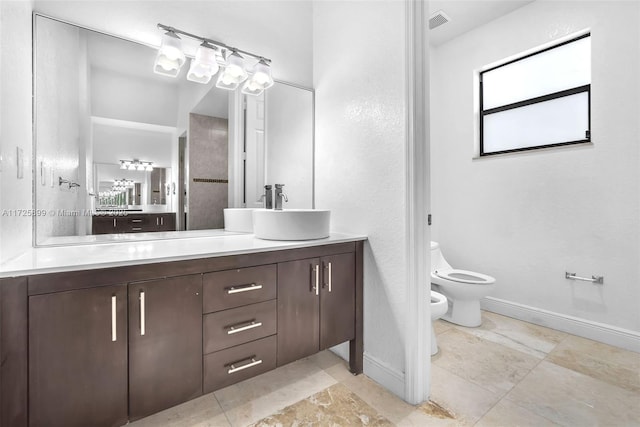 bathroom featuring a bidet, vanity, and toilet