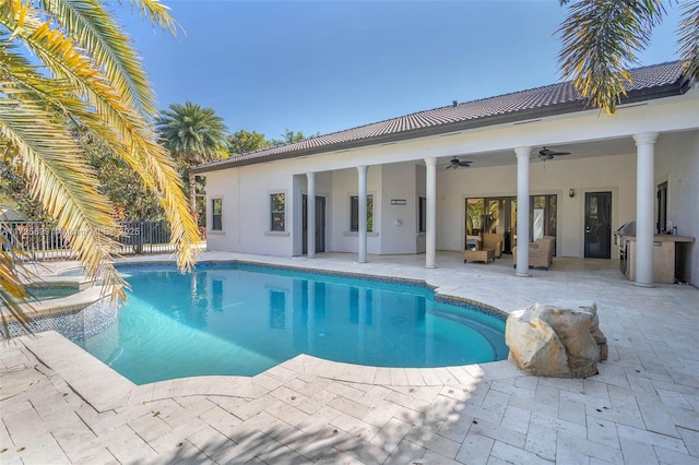 view of swimming pool with an in ground hot tub, ceiling fan, exterior kitchen, and a patio area