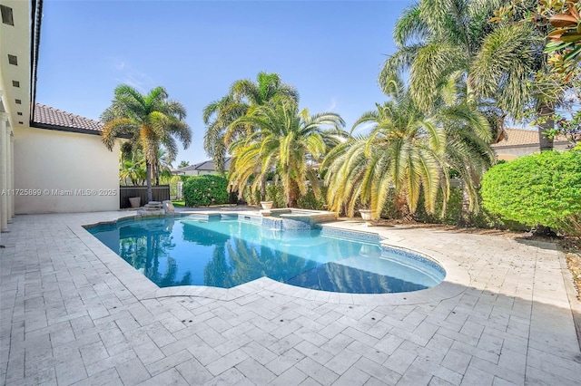 view of pool with an in ground hot tub and a patio