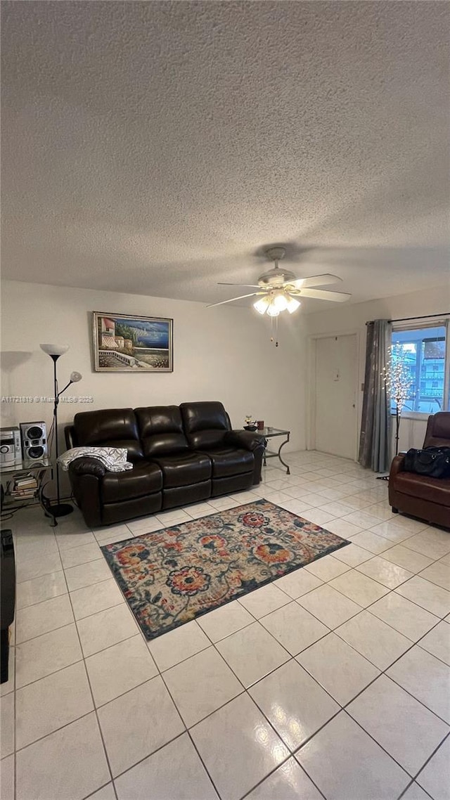 tiled living room with a textured ceiling and ceiling fan