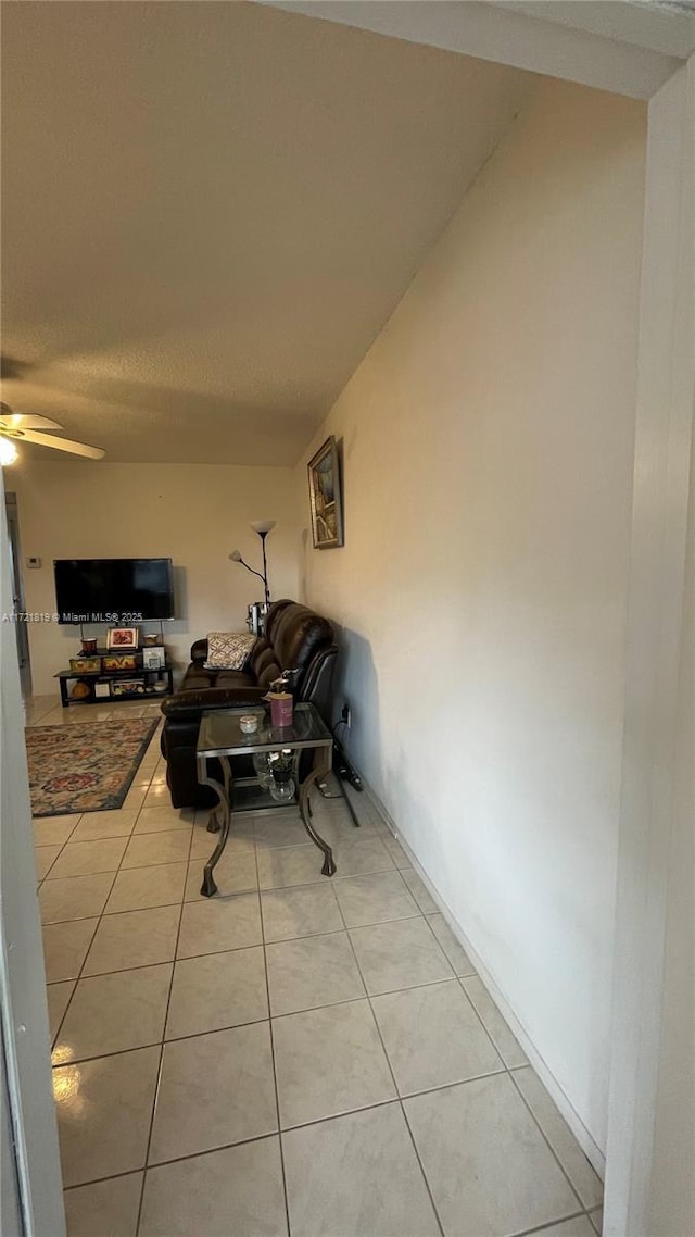 exterior space with ceiling fan and light tile patterned floors