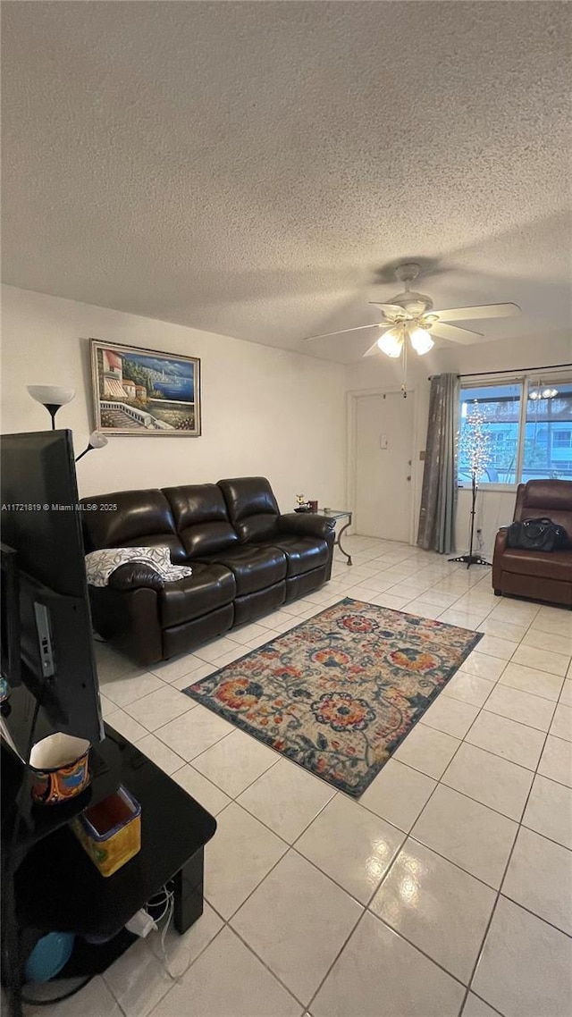 tiled living room featuring ceiling fan and a textured ceiling