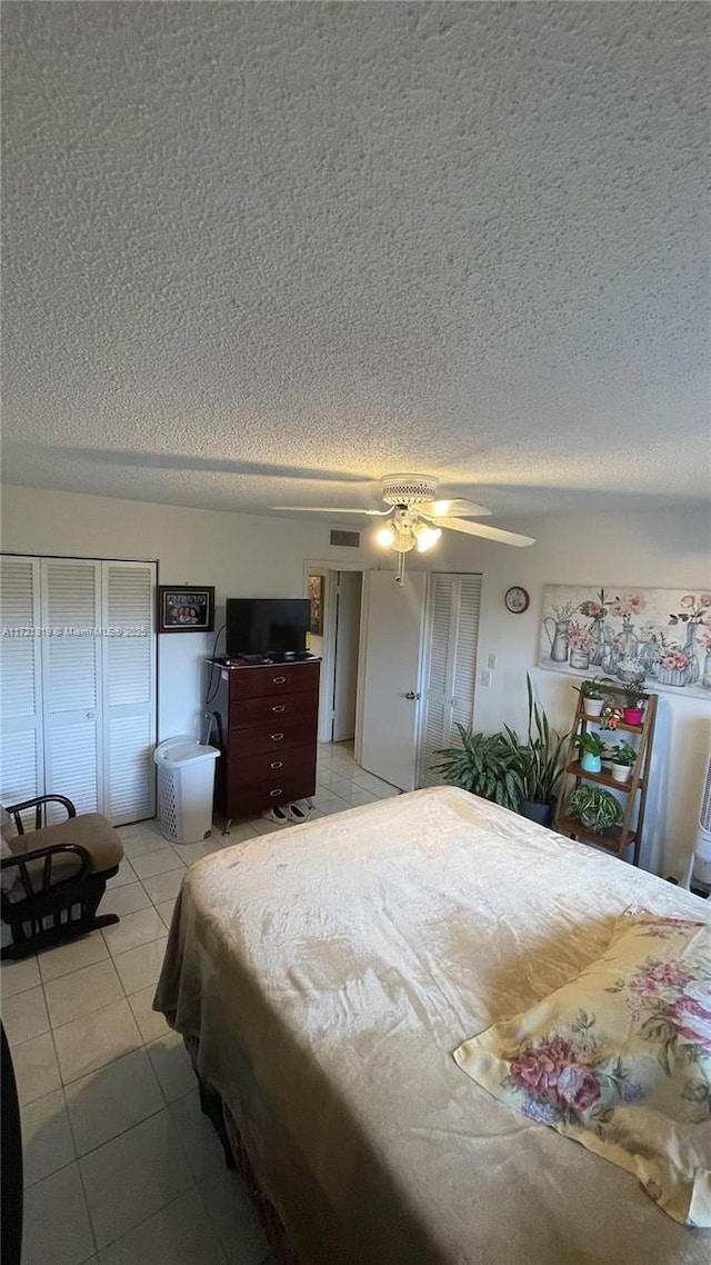 tiled bedroom with ceiling fan