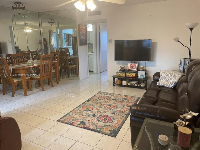 tiled living room featuring ceiling fan