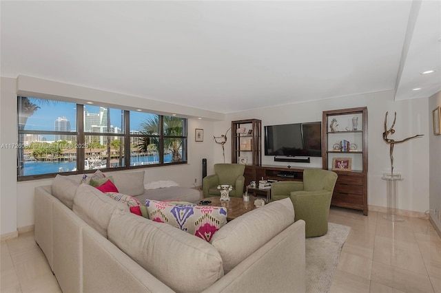 living room with light tile patterned flooring and a water view